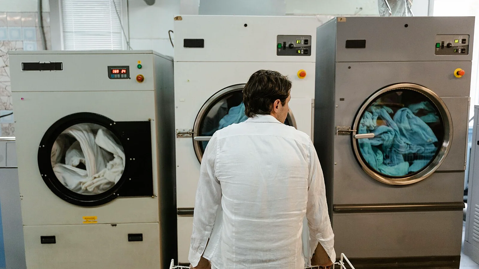 Row of stacked commercial dryers in a laundromat